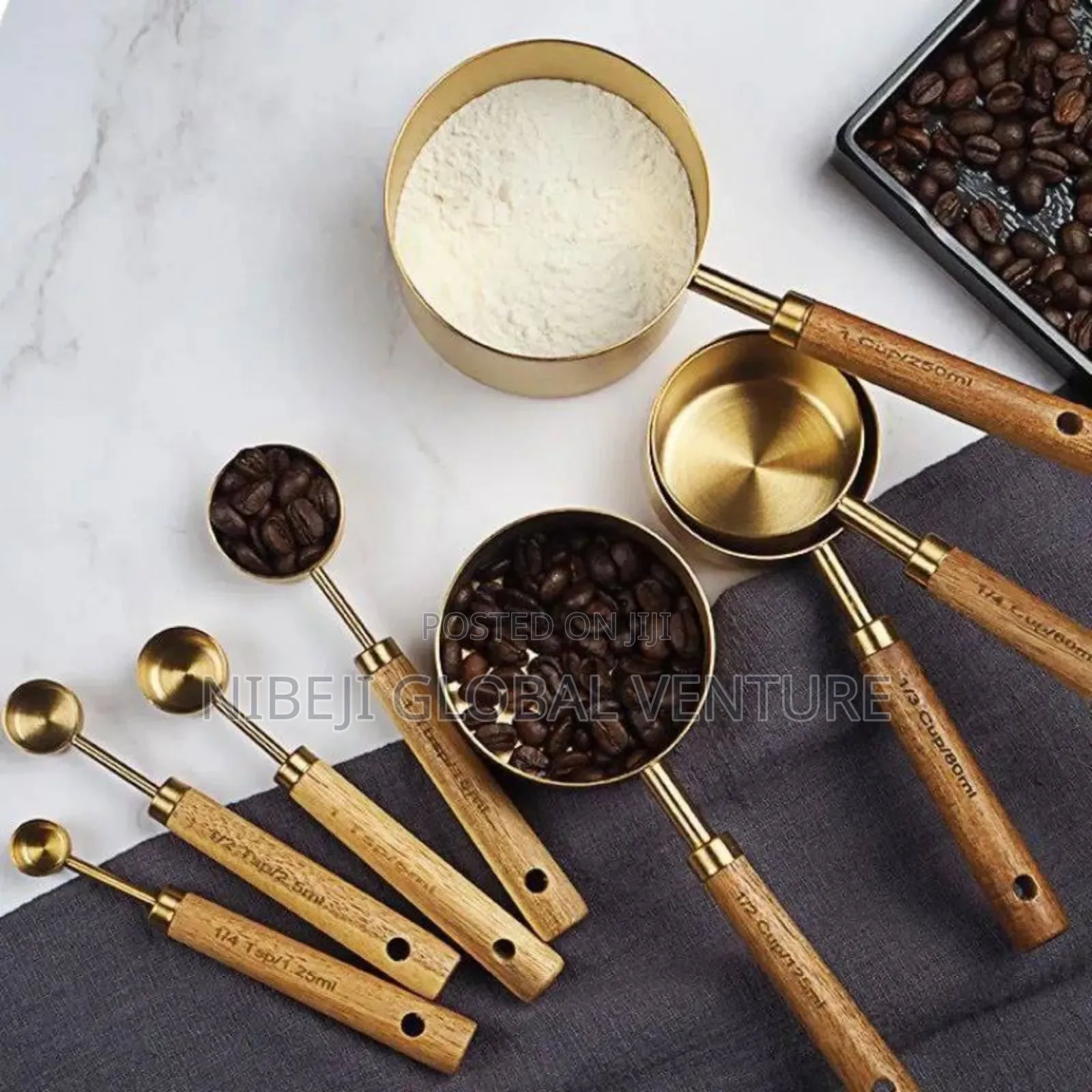 A Set of Eight Stainless Steel Measuring Cup