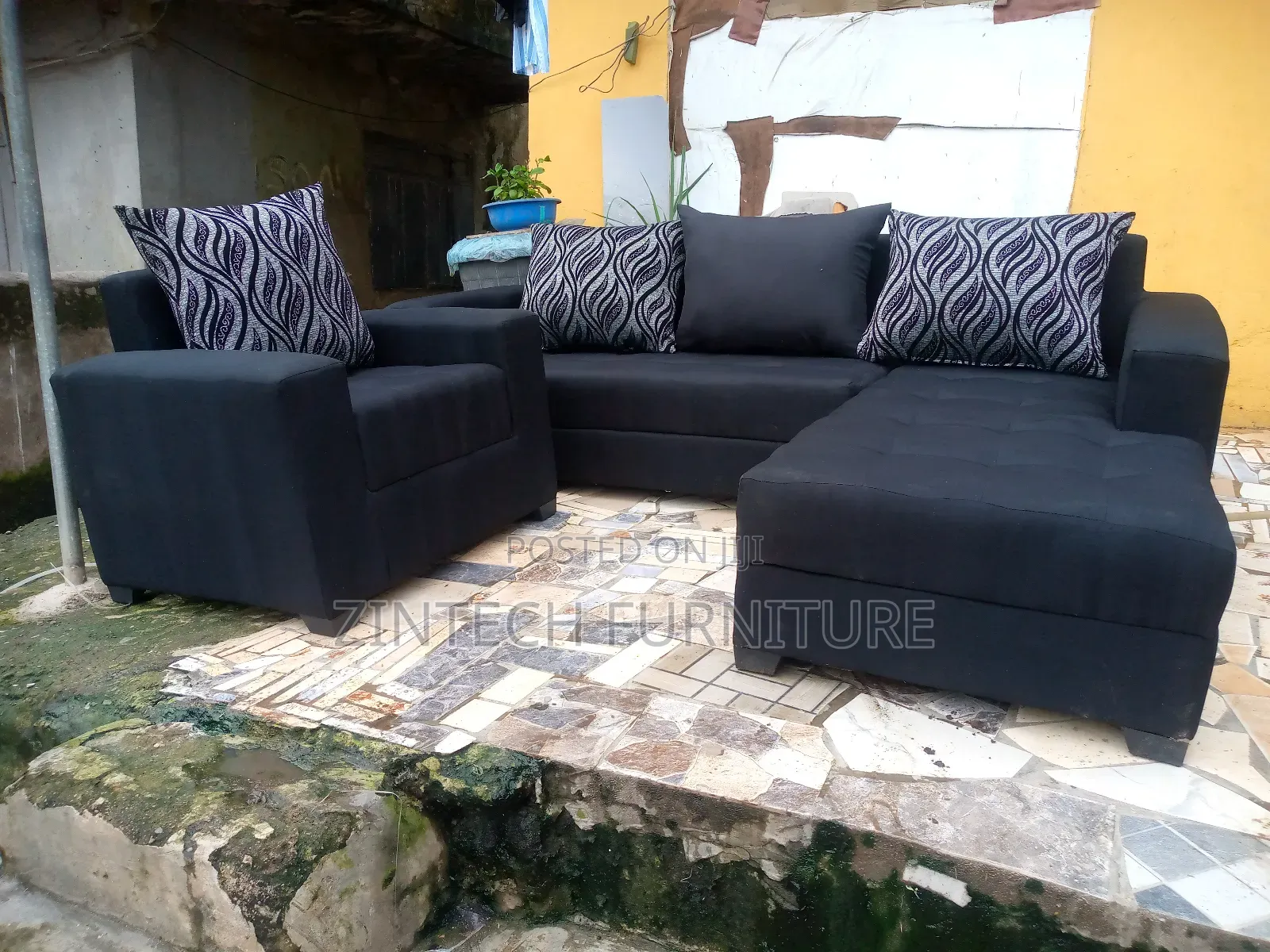L Shaped Black Color Sofas and a Single Seater