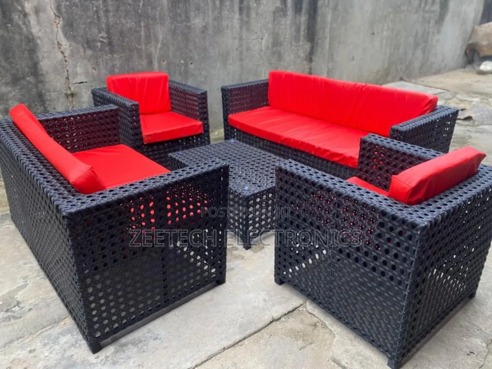 Standard Ratten Wicker Outdoor Sofa Set With Red Cushions.