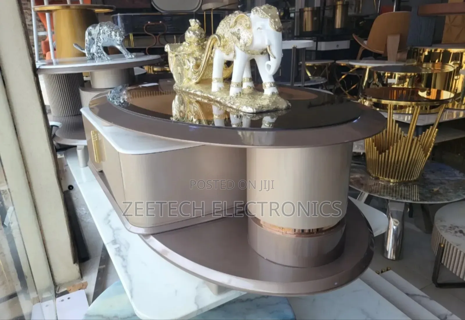 Modern, Oval-Shaped Coffee Table With a Glossy, a Mirrored Top.