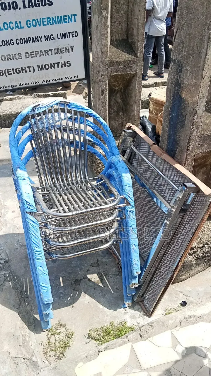 A Set of Outdoor Stainless Folding Table 4 Stackable Chairs