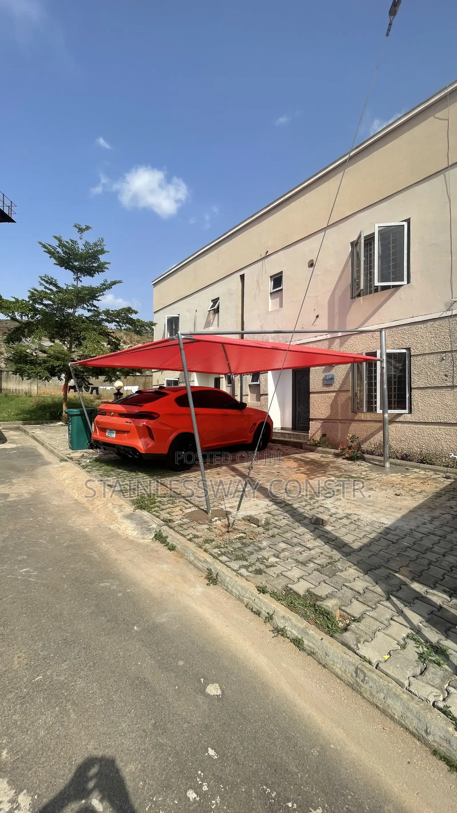 Carport With Galvanized Pipe and Red Cover: Tough, Bright