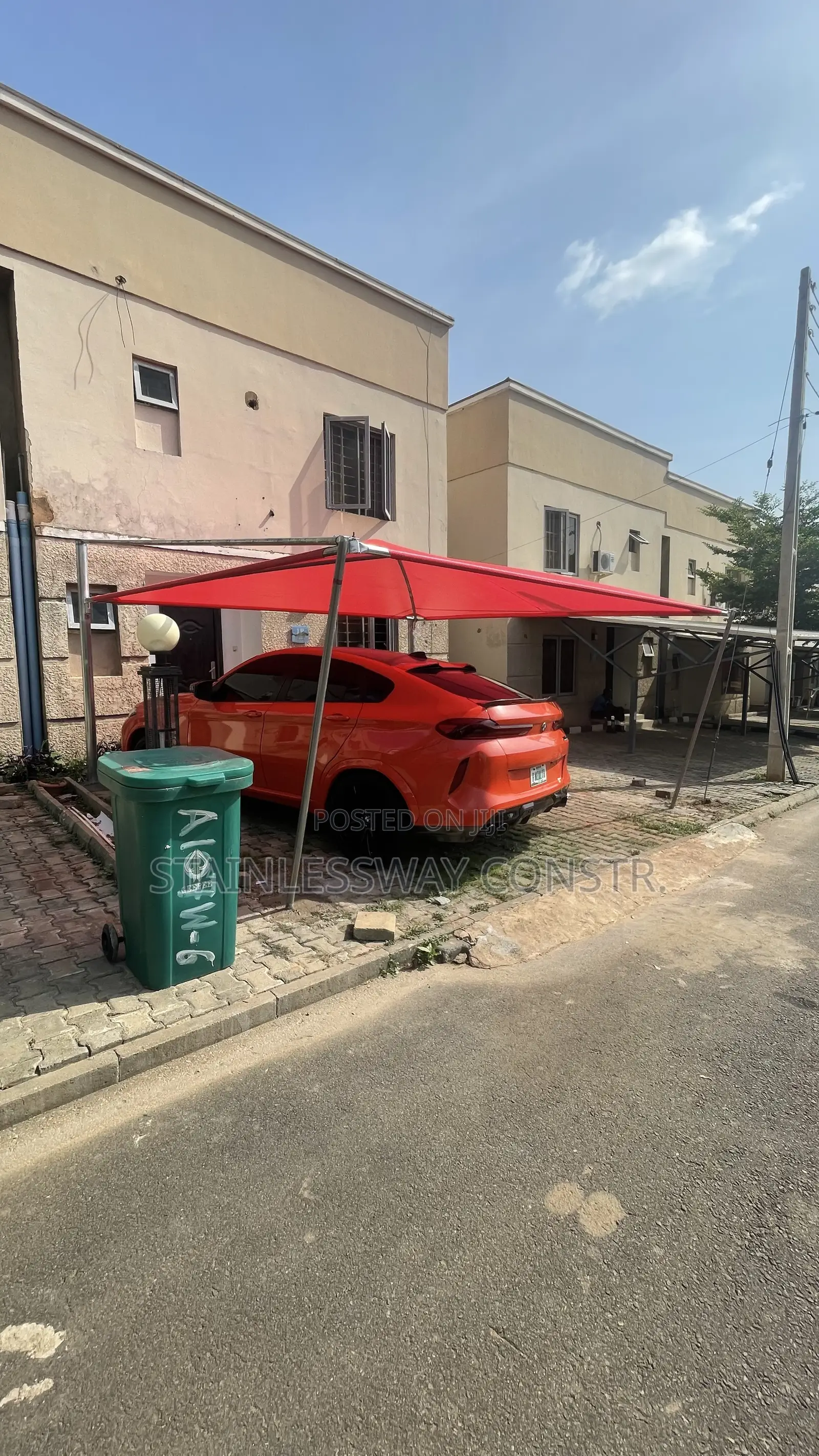 Carport With Galvanized Pipe and Red Cover: Tough, Bright