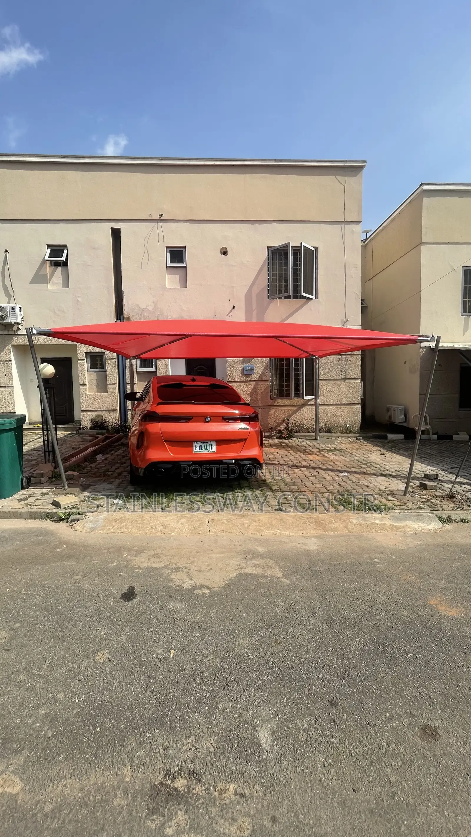 Carport With Galvanized Pipe and Red Cover: Tough, Bright