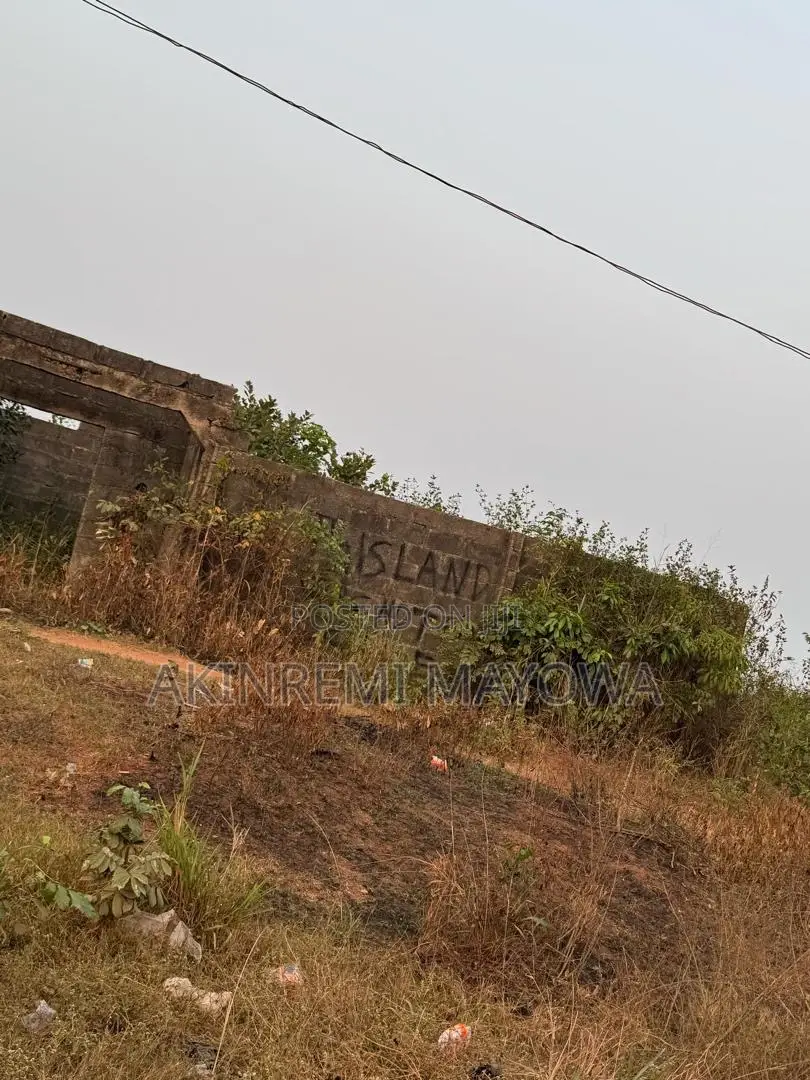 1 Acre of Land Fenceddirectly With 4 Shops