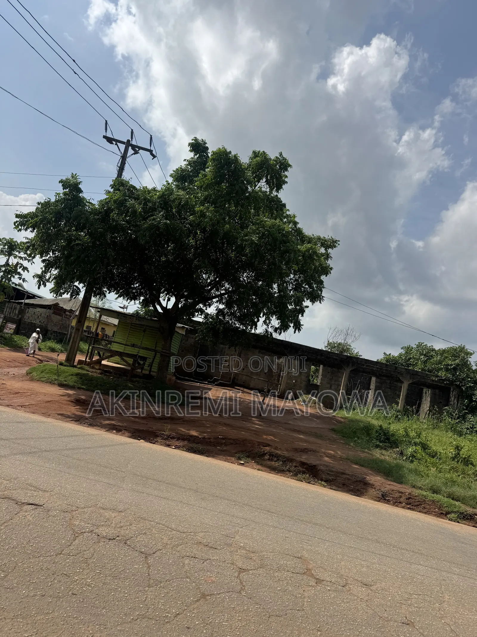 1 Acre of Land Fenceddirectly With 4 Shops