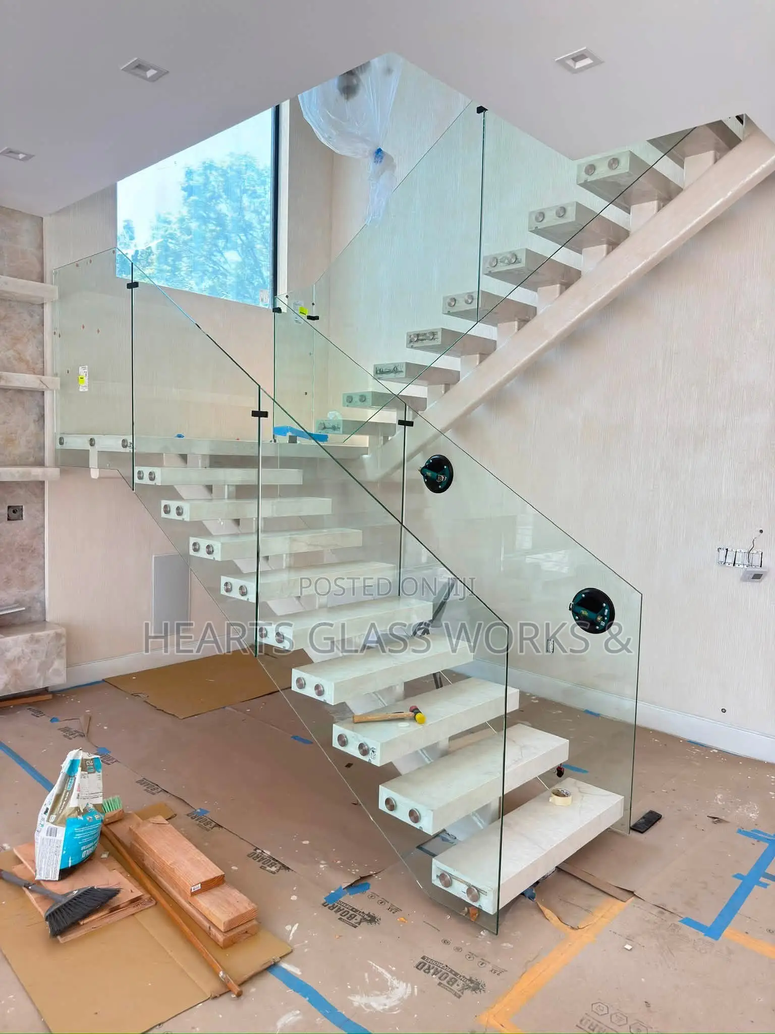 Floating Stairs Installer With Solid Wrought Iron and Tempered Glass