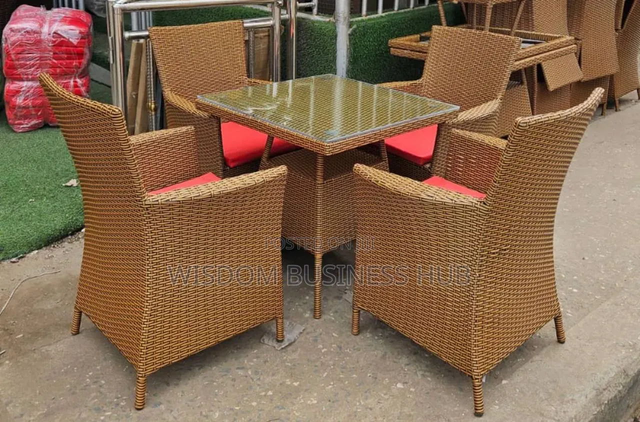 Glass Top Rattan Dining Table With Cushioned Armchairs