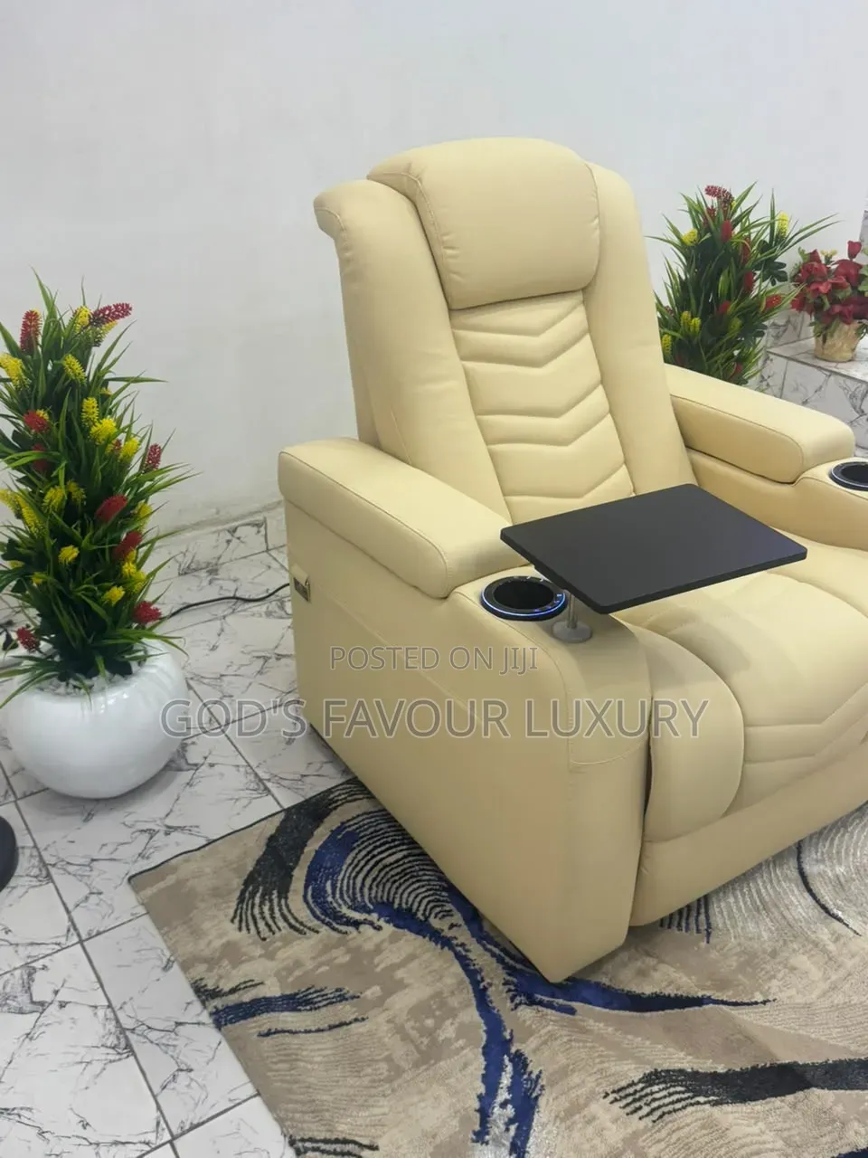 This Cream Leather Recliner Features a Built-in Tray Table .
