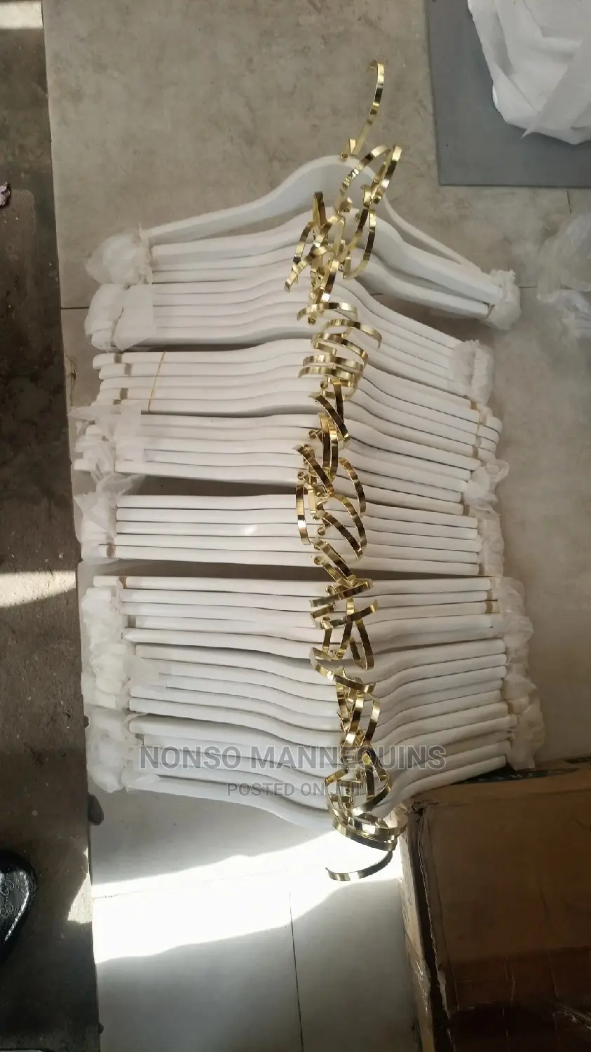 White and Gold Wooden Clothes Hangers