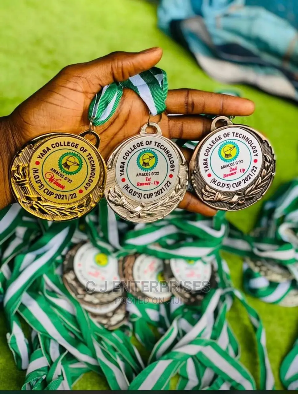 Silver, Gold and Bronze Medal With Green and White Rope