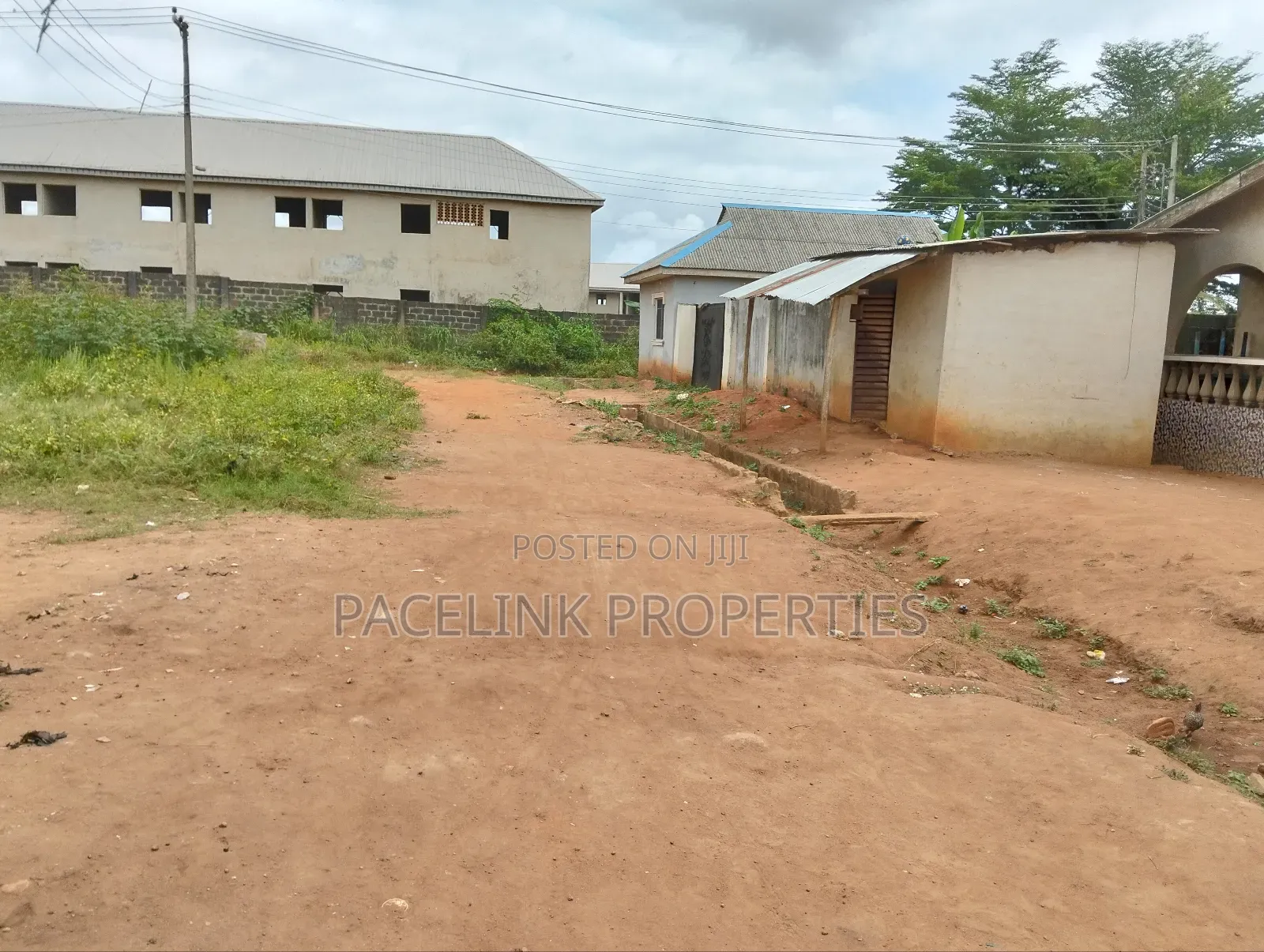 Half Plot of Land With Two Shops