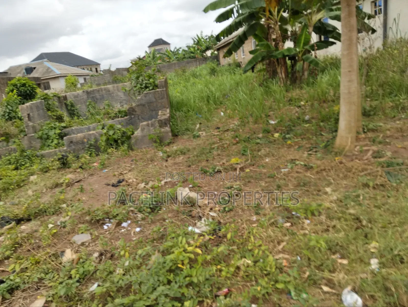 Half Plot of Land With Two Shops