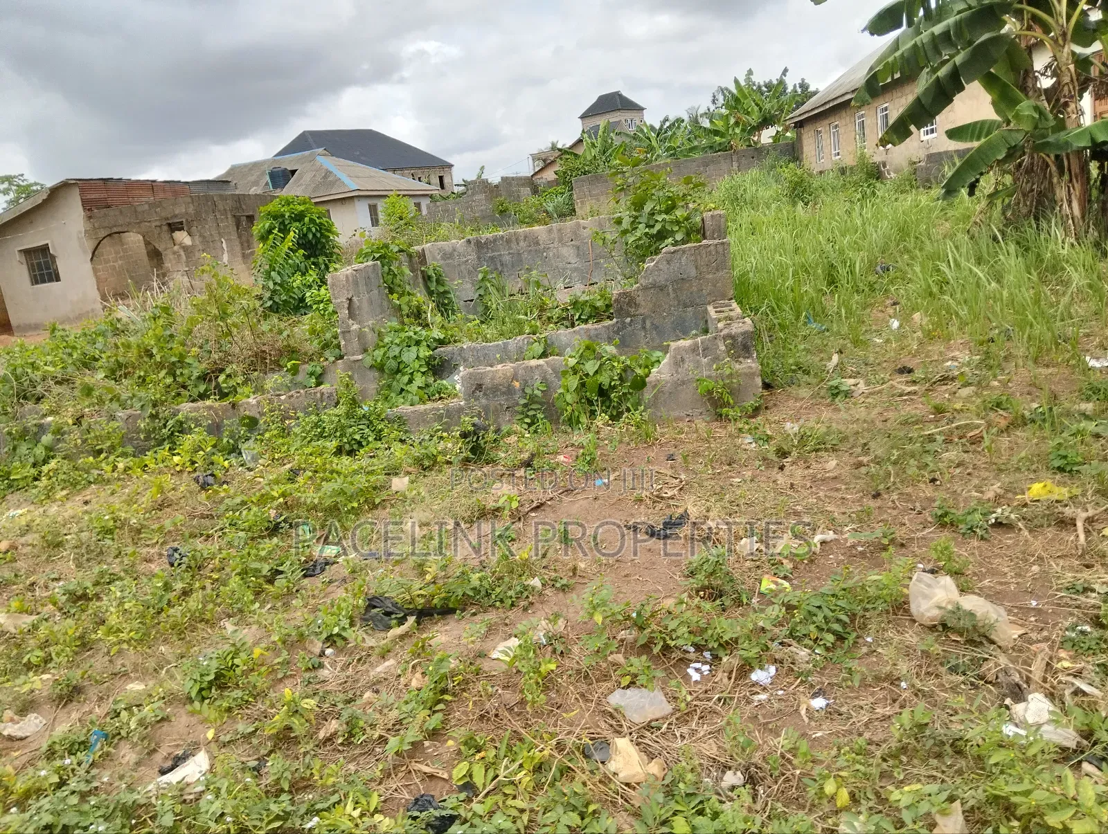 Half Plot of Land With Two Shops