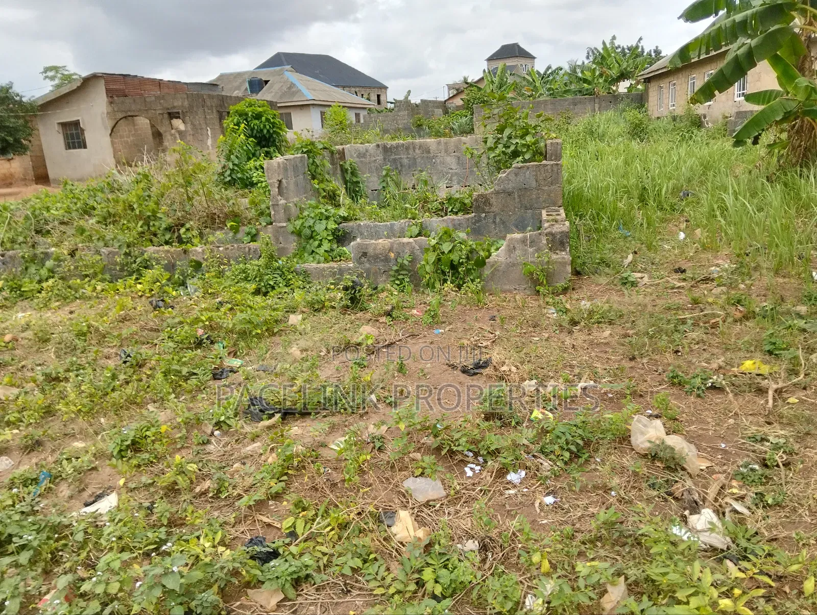 Half Plot of Land With Two Shops