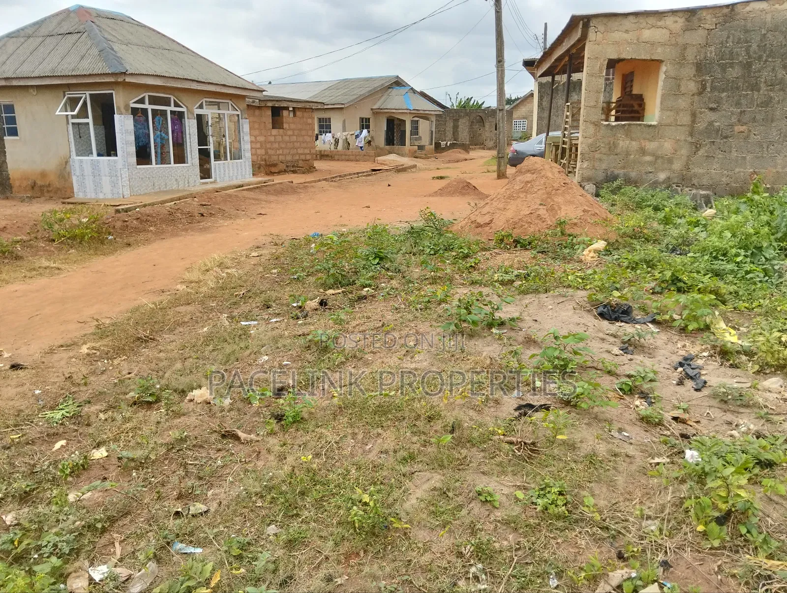 Half Plot of Land With Two Shops
