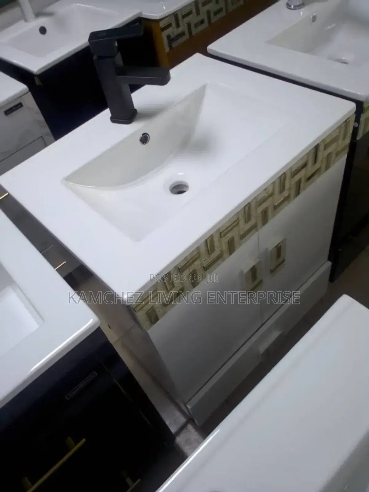 Modern White Sink Vanity With Black Faucet and Decor Accent