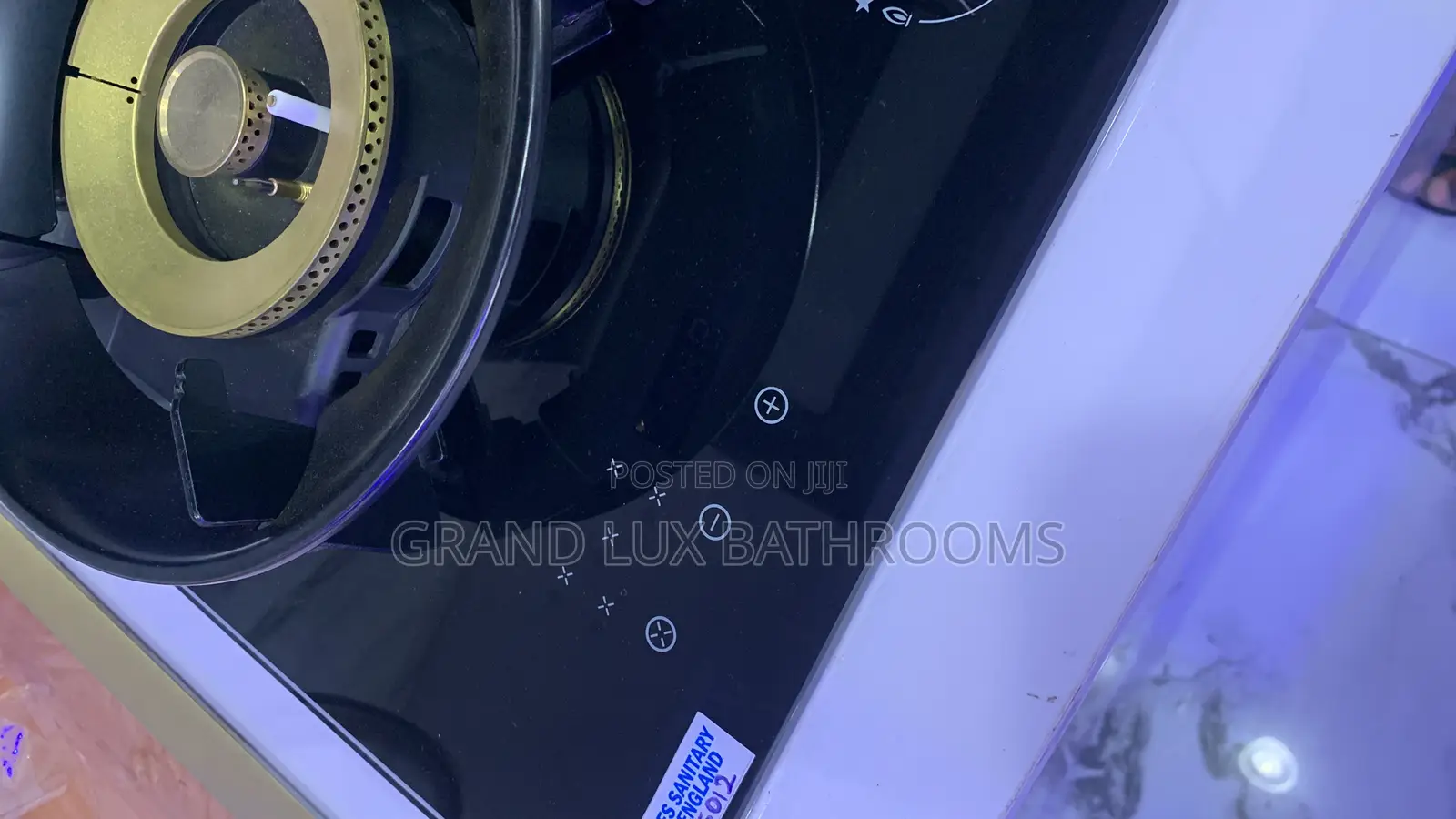 A Modern Black Gas Hob With Five Gold-Accented Burners