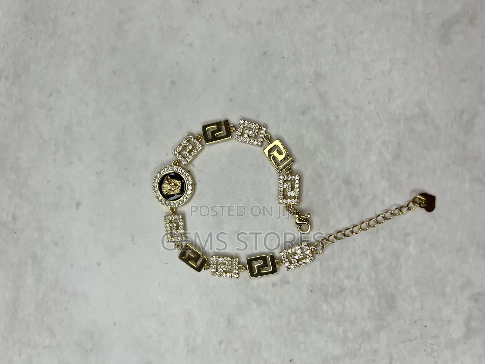 Luxurious Gold-Toned Bracelet With Medusa Medallion Crystal Details