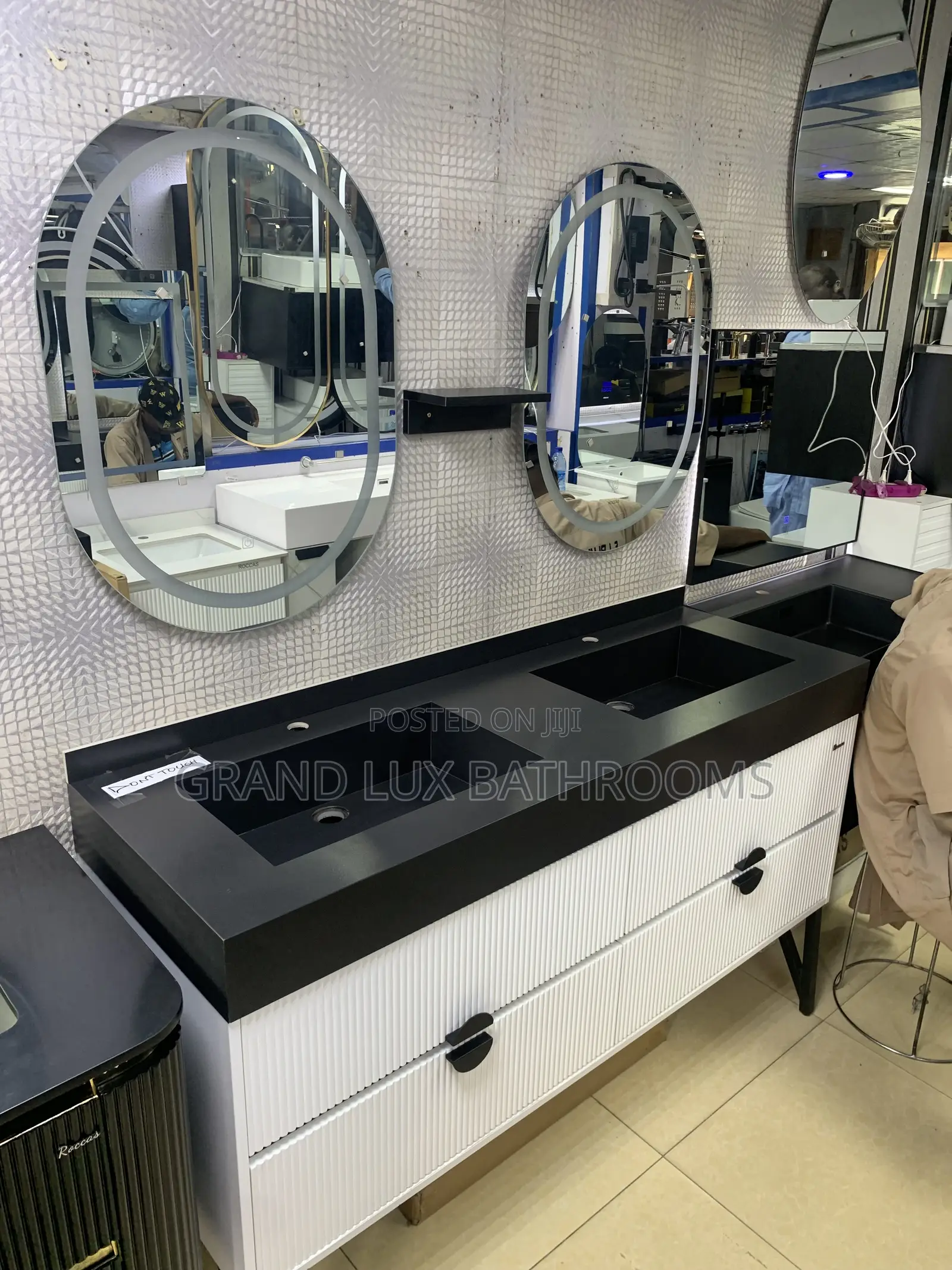 **Modern Double Sink Vanity With Oval Mirrors and Textured Wall Finish