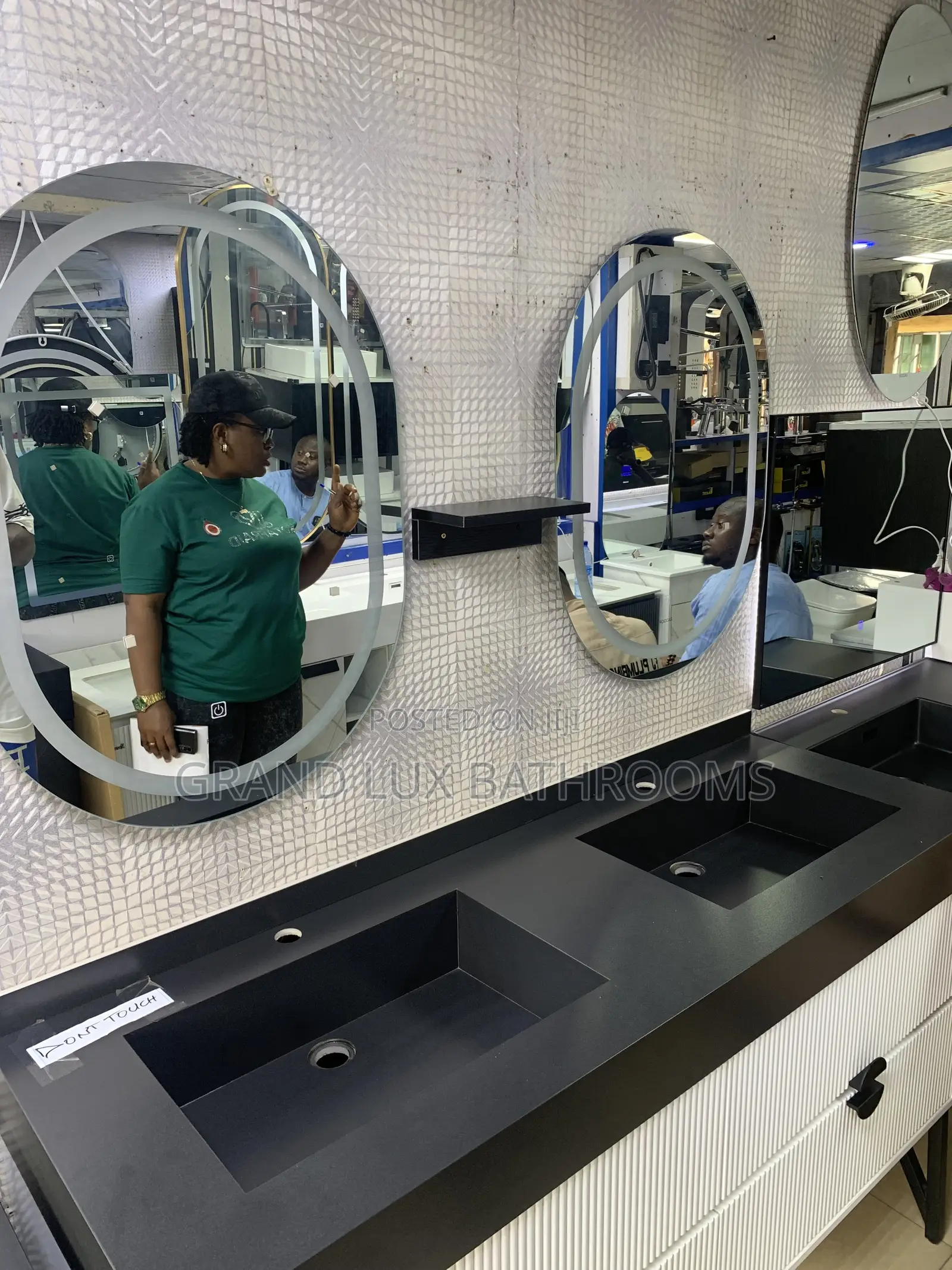 **Modern Double Sink Vanity With Oval Mirrors and Textured Wall Finish