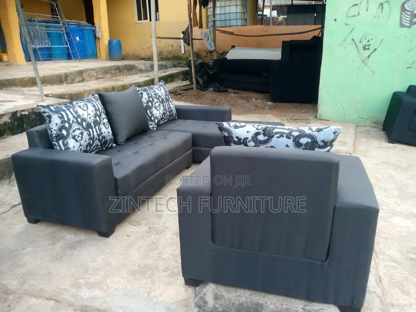 Dark Grey L Shape Couch and a Single Seater
