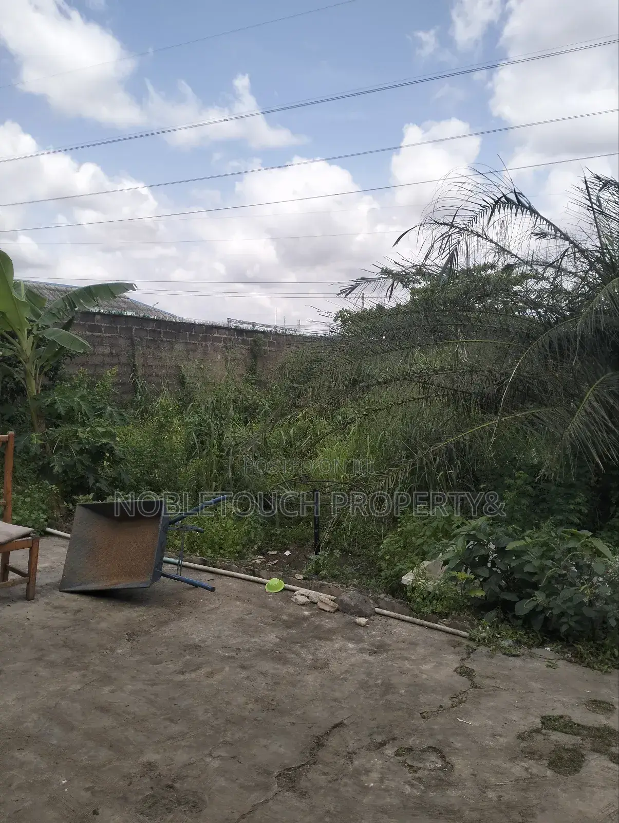 Dry Table Land With 4-Shops at Oluwaga Ipaja Ayobo Lagos