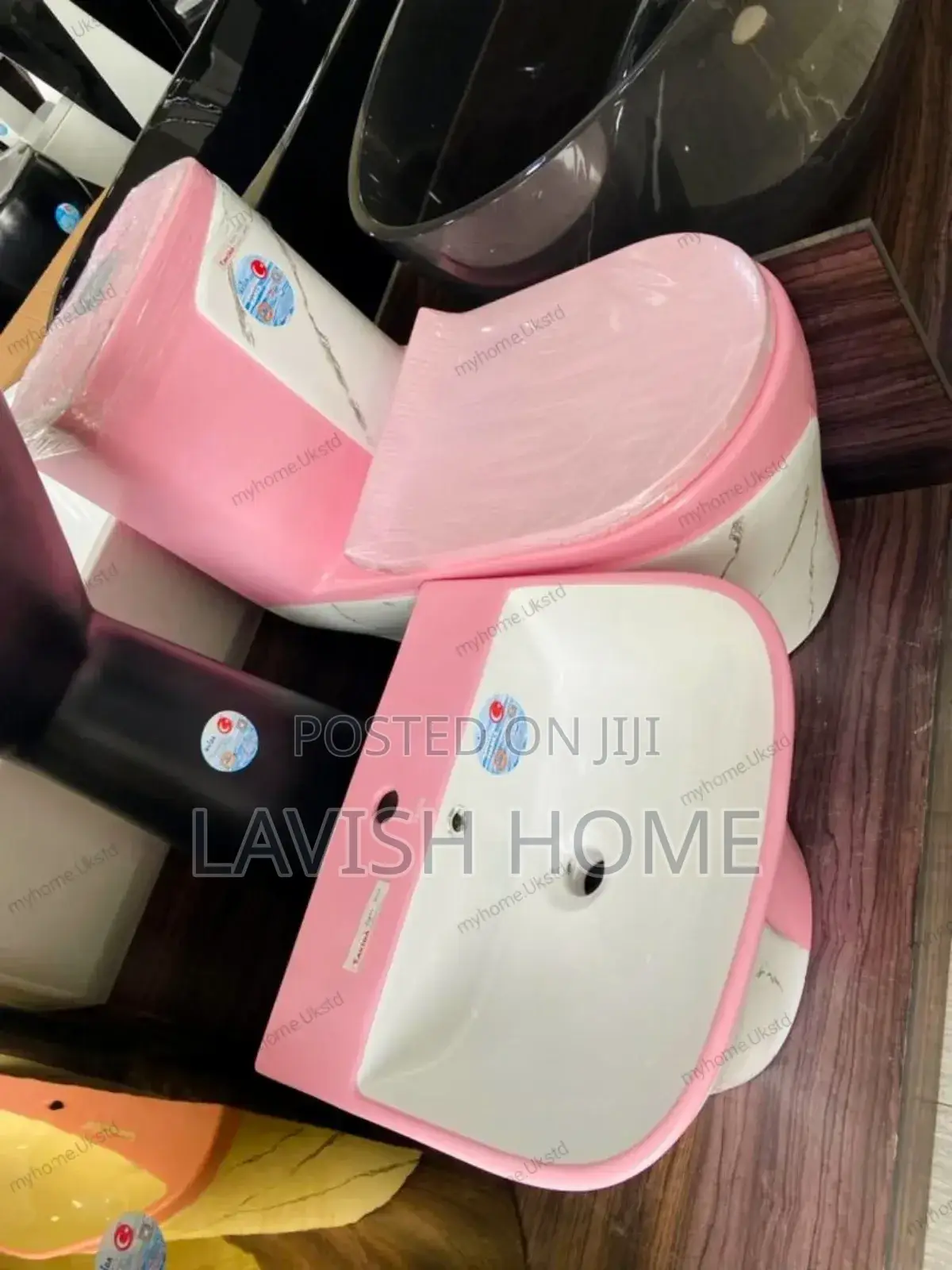Pink and White Water Closet With Hanging Basin