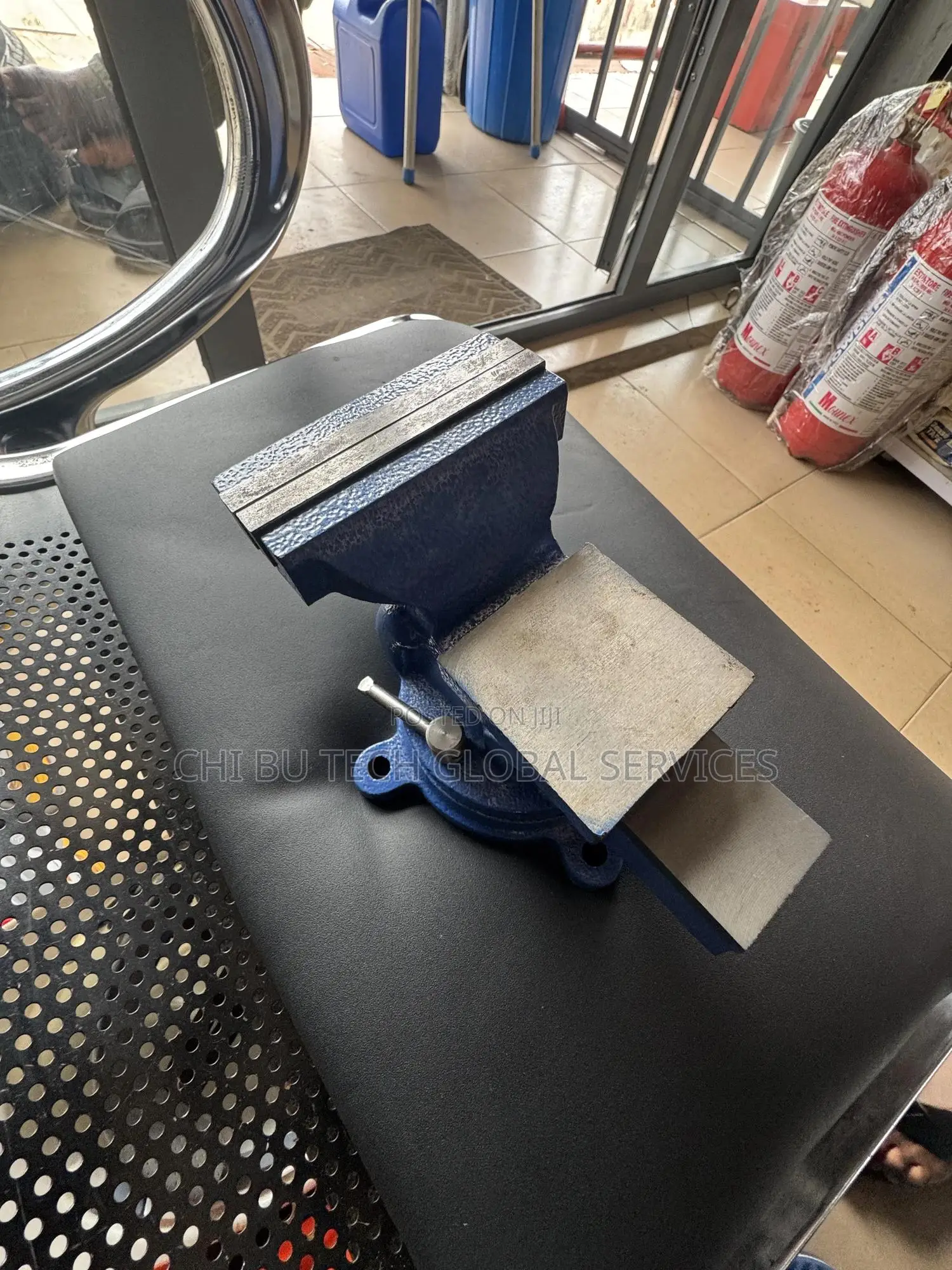 Blue Bench Vise With an Anvil and Swivel Base.