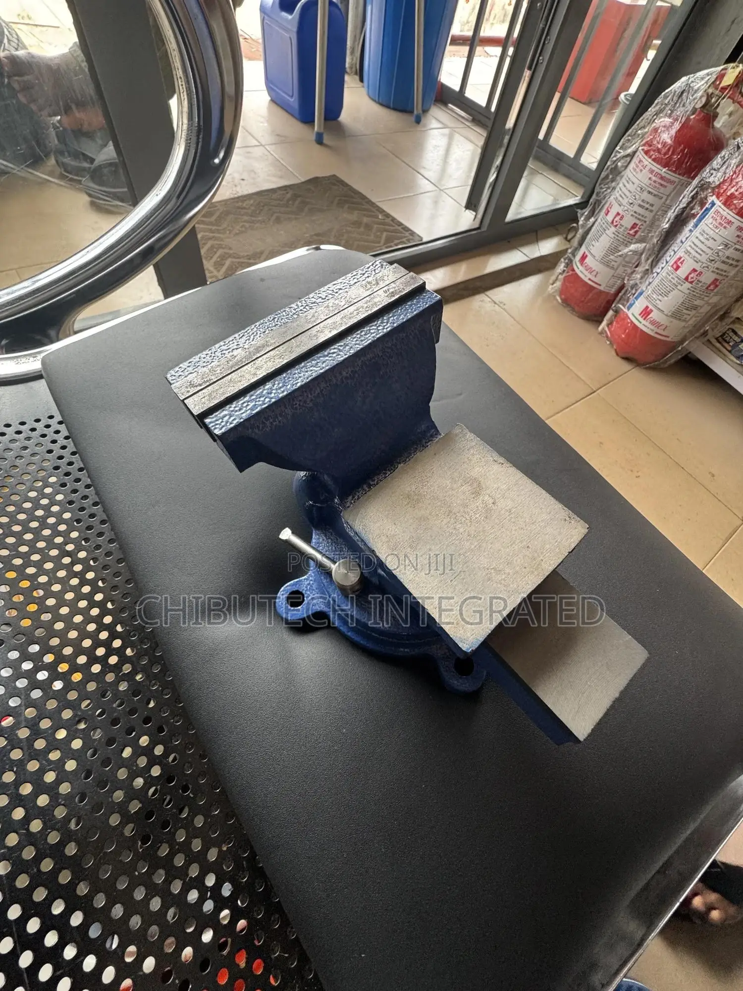 Blue Bench Vise With an Anvil and Swivel Base.