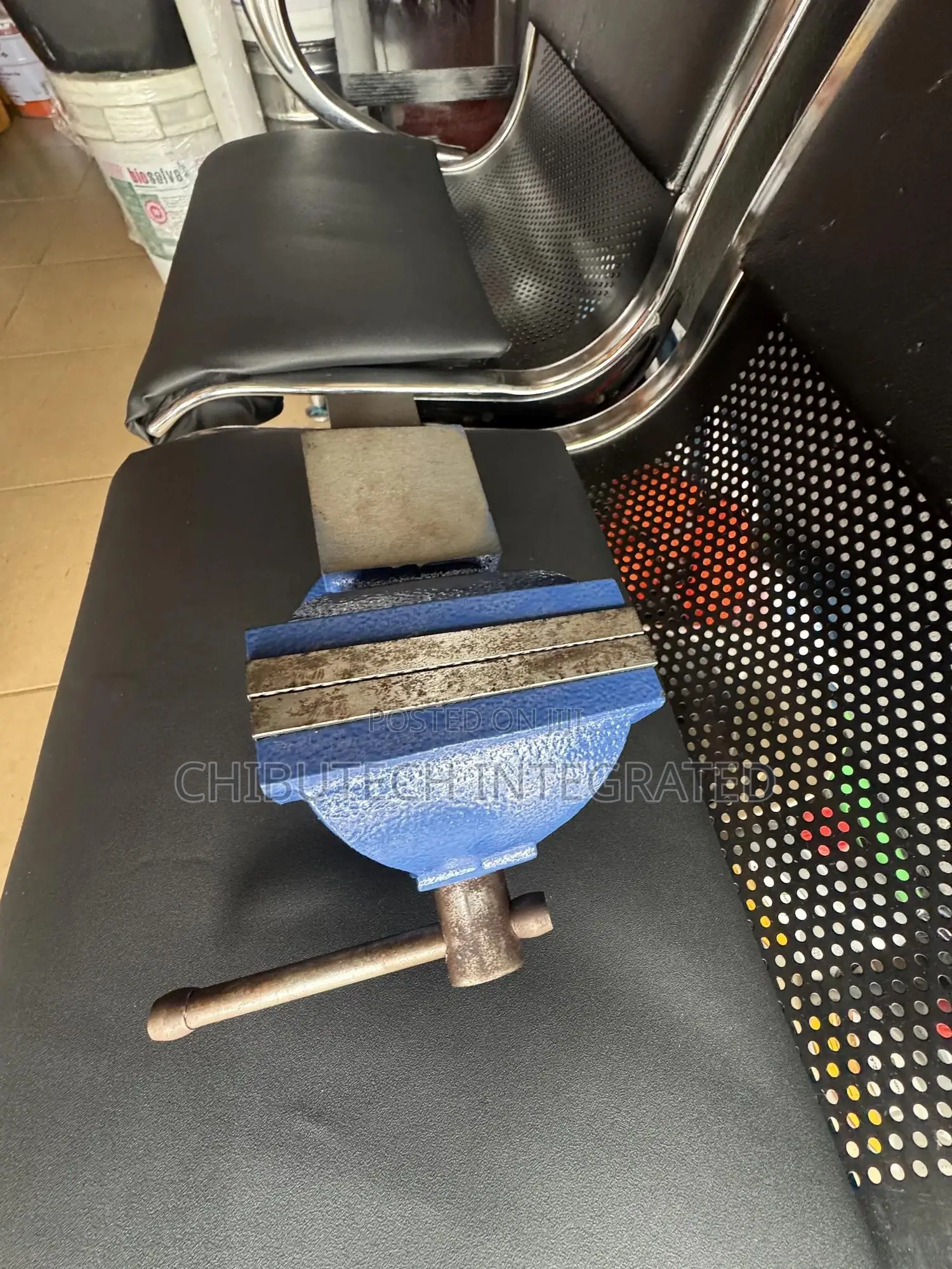 Blue Bench Vise With an Anvil and Swivel Base.