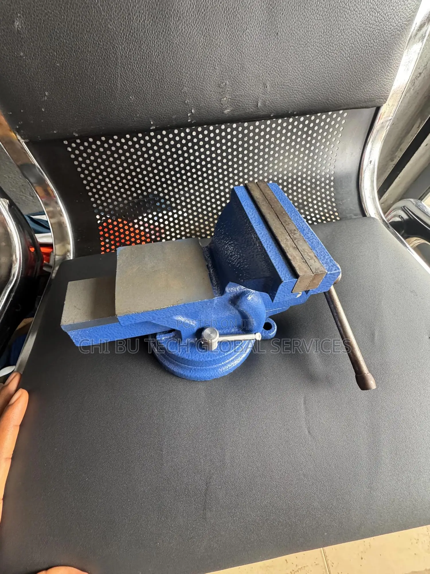 Blue Bench Vise With an Anvil and Swivel Base.