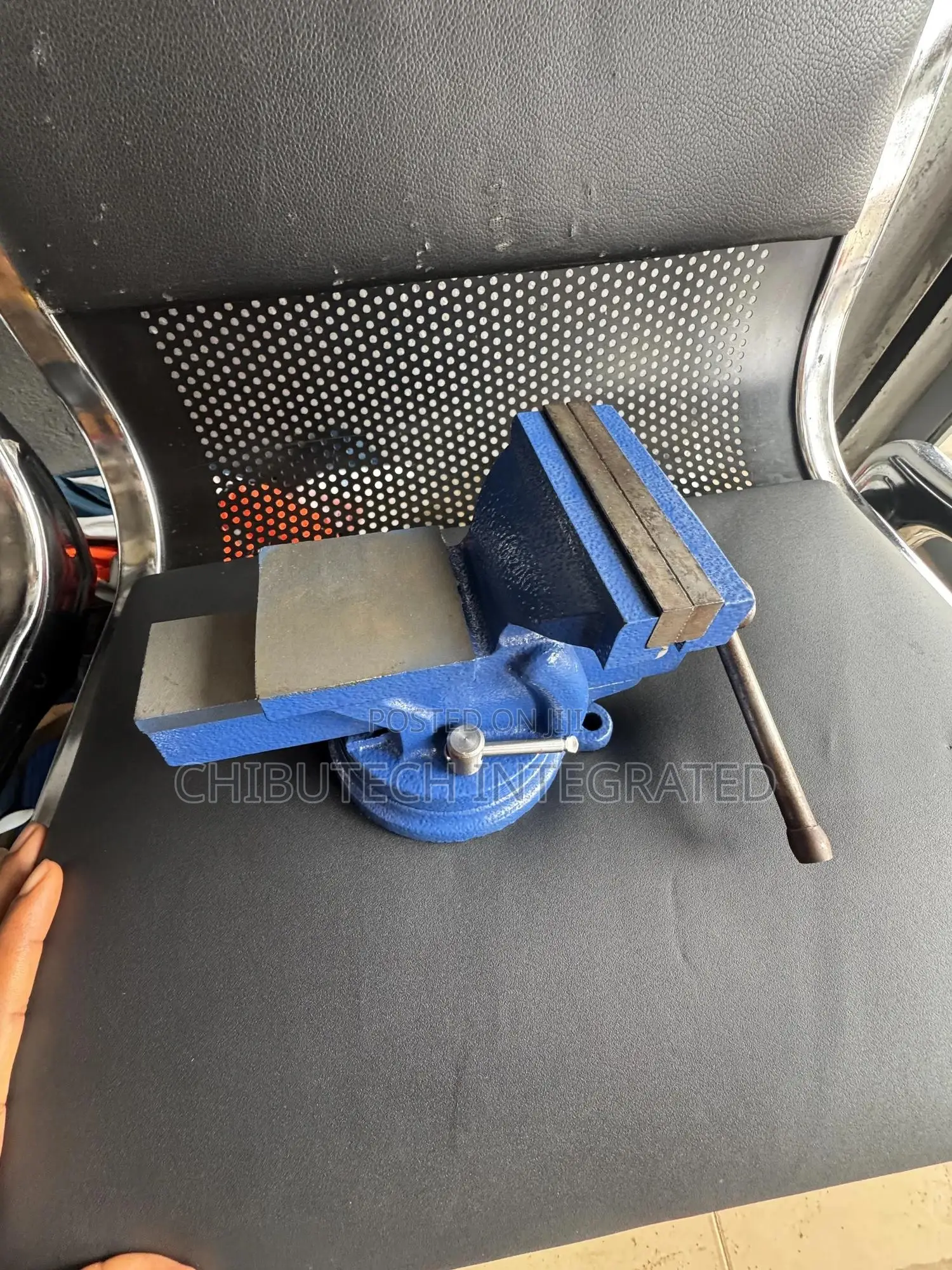 Blue Bench Vise With an Anvil and Swivel Base.