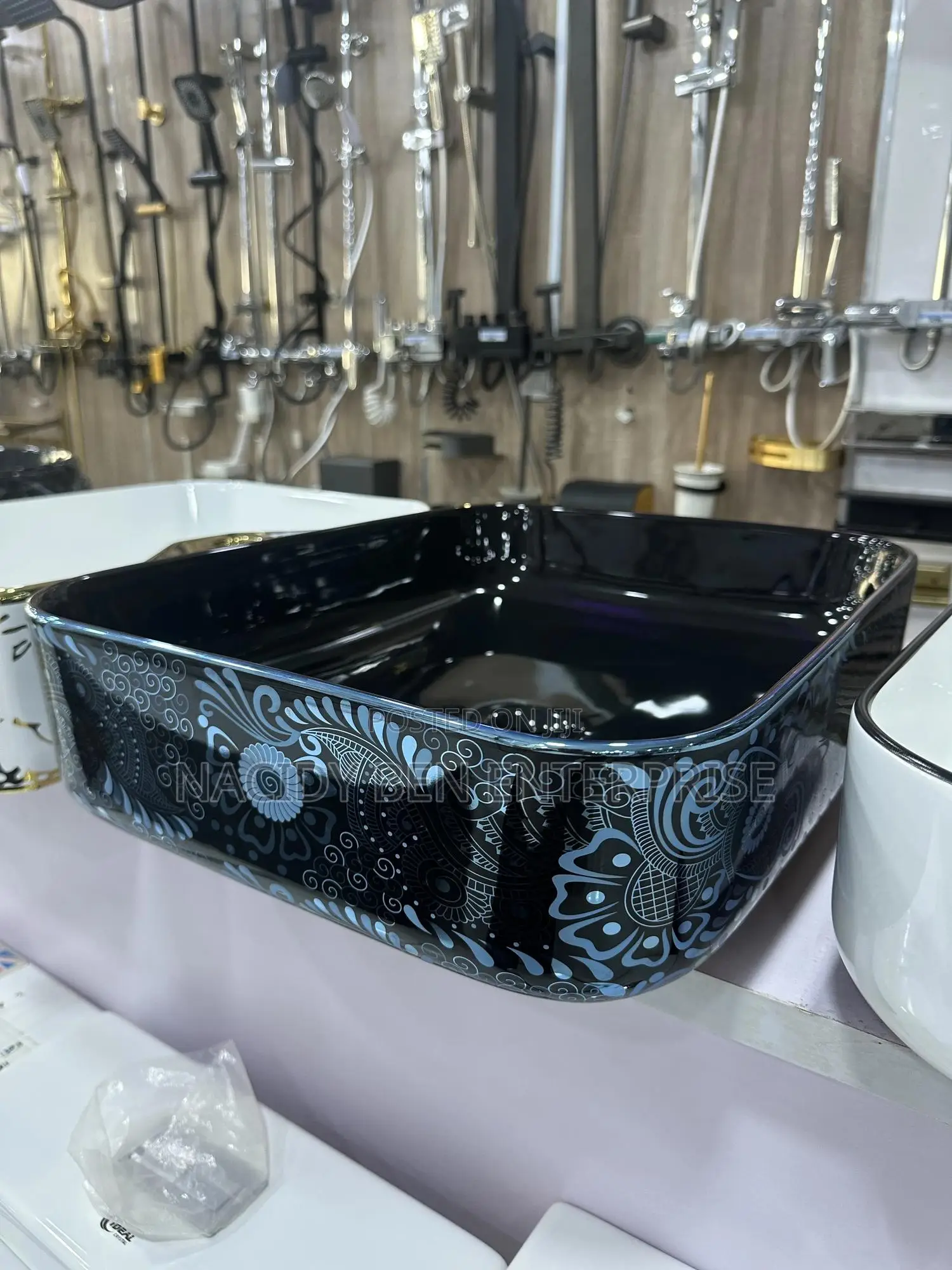Black Ceramic Vessel Washbasin With a Blue Paisley or Damask Pattern.