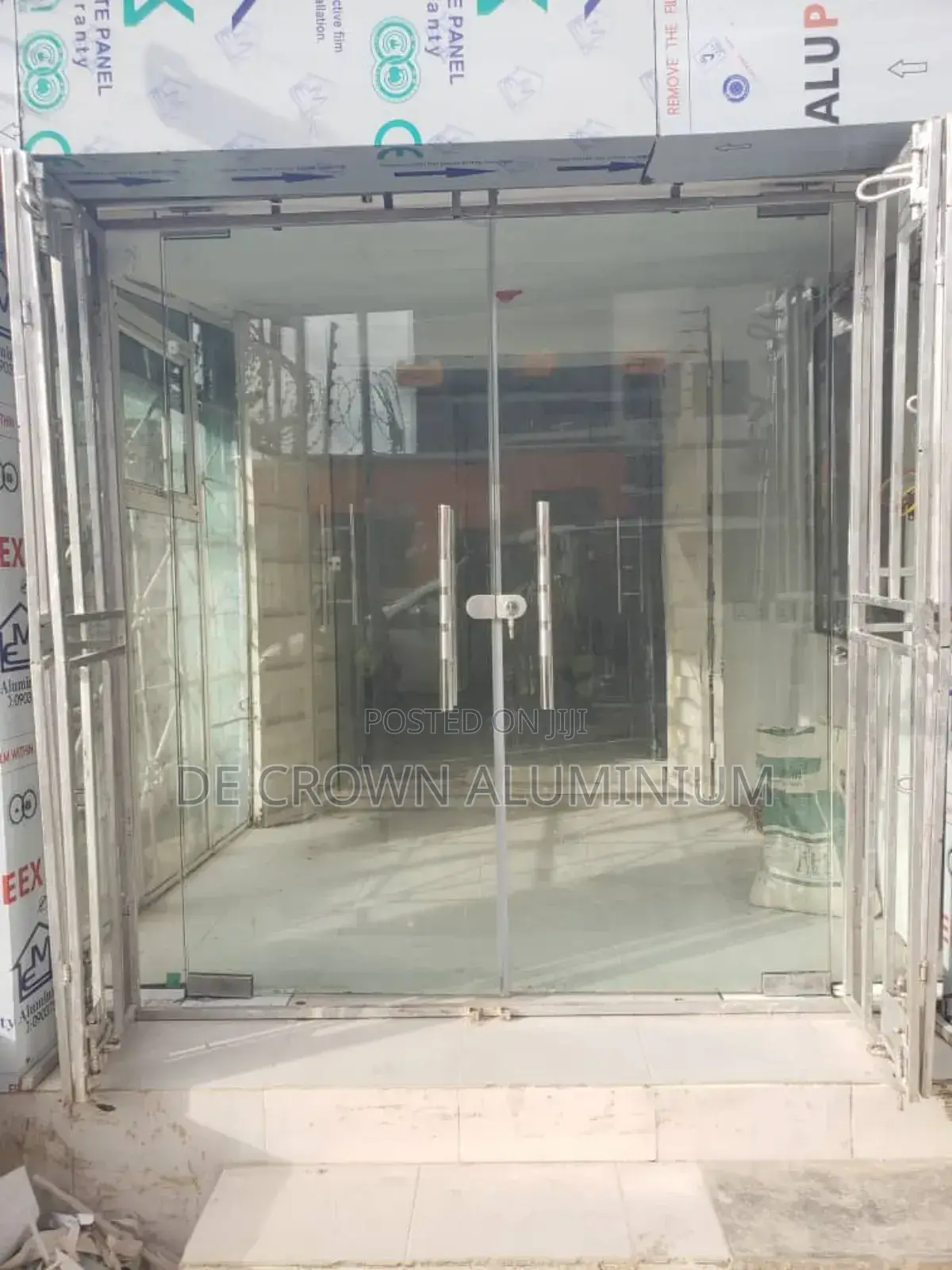 Luxury Frameless Glass Shop Entrance Door With Silver Finish