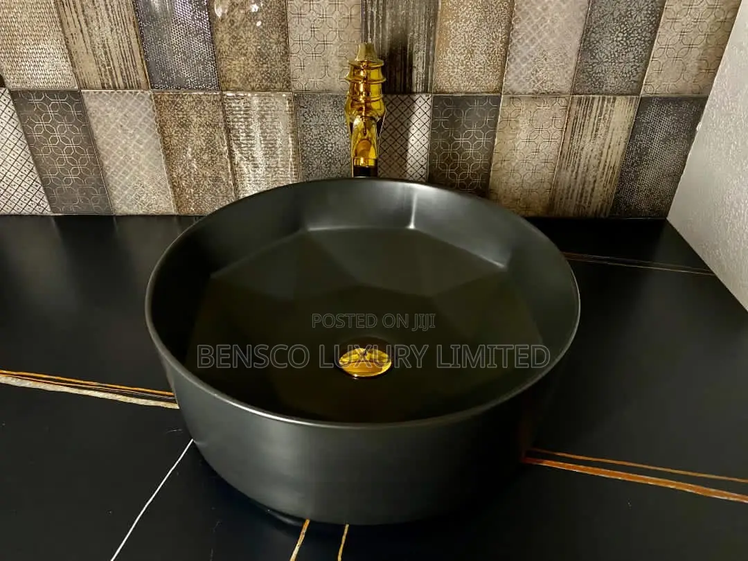 A Black Round Countertop Wash Had Basin