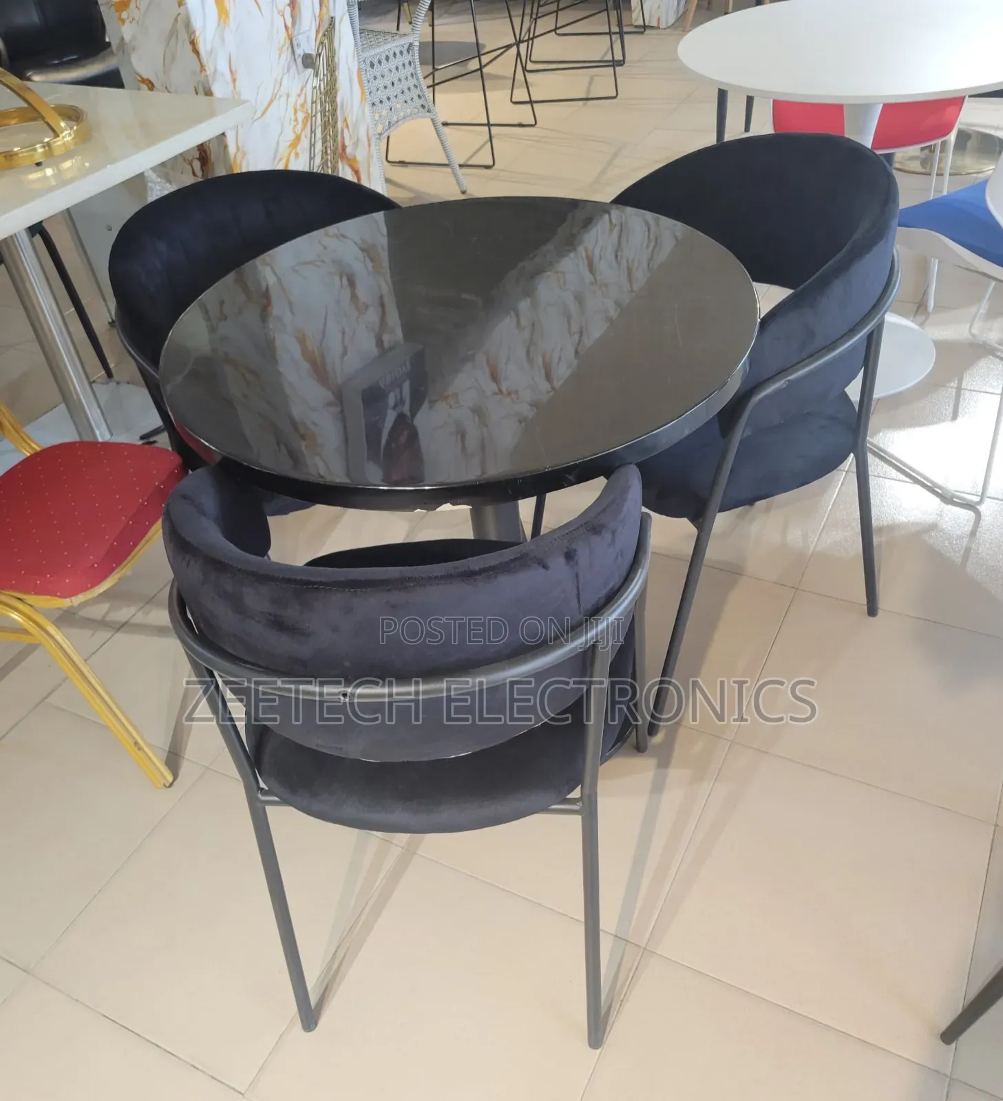 Round Black Glass Dining Table With 3 Dark Velvet Chairs.
