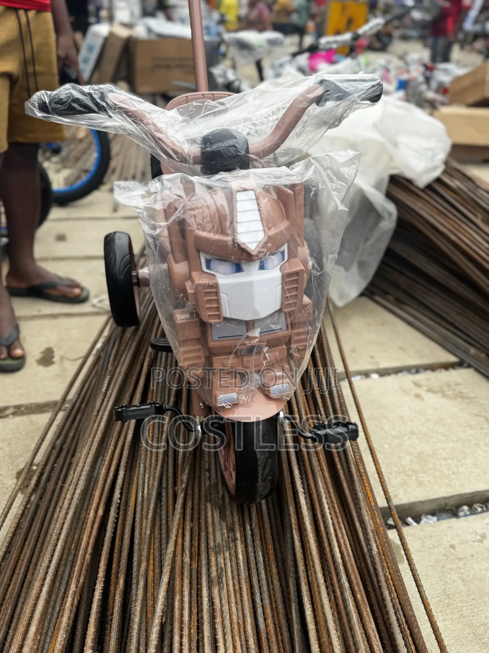 Children's Tricycle With a Robot-Themed Front and Handle.