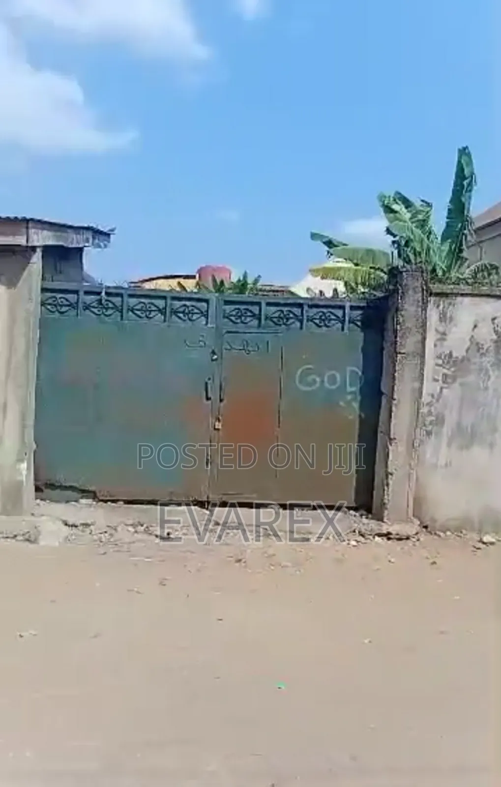 A Plot of Land Fenced With Gate, With 5 Shops.