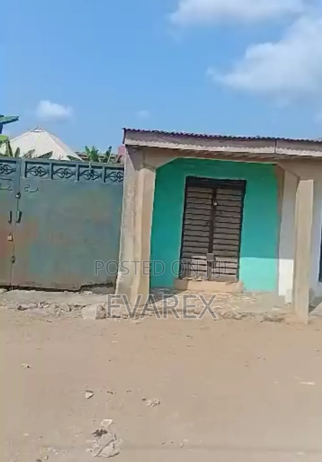 A Plot of Land Fenced With Gate, With 5 Shops.