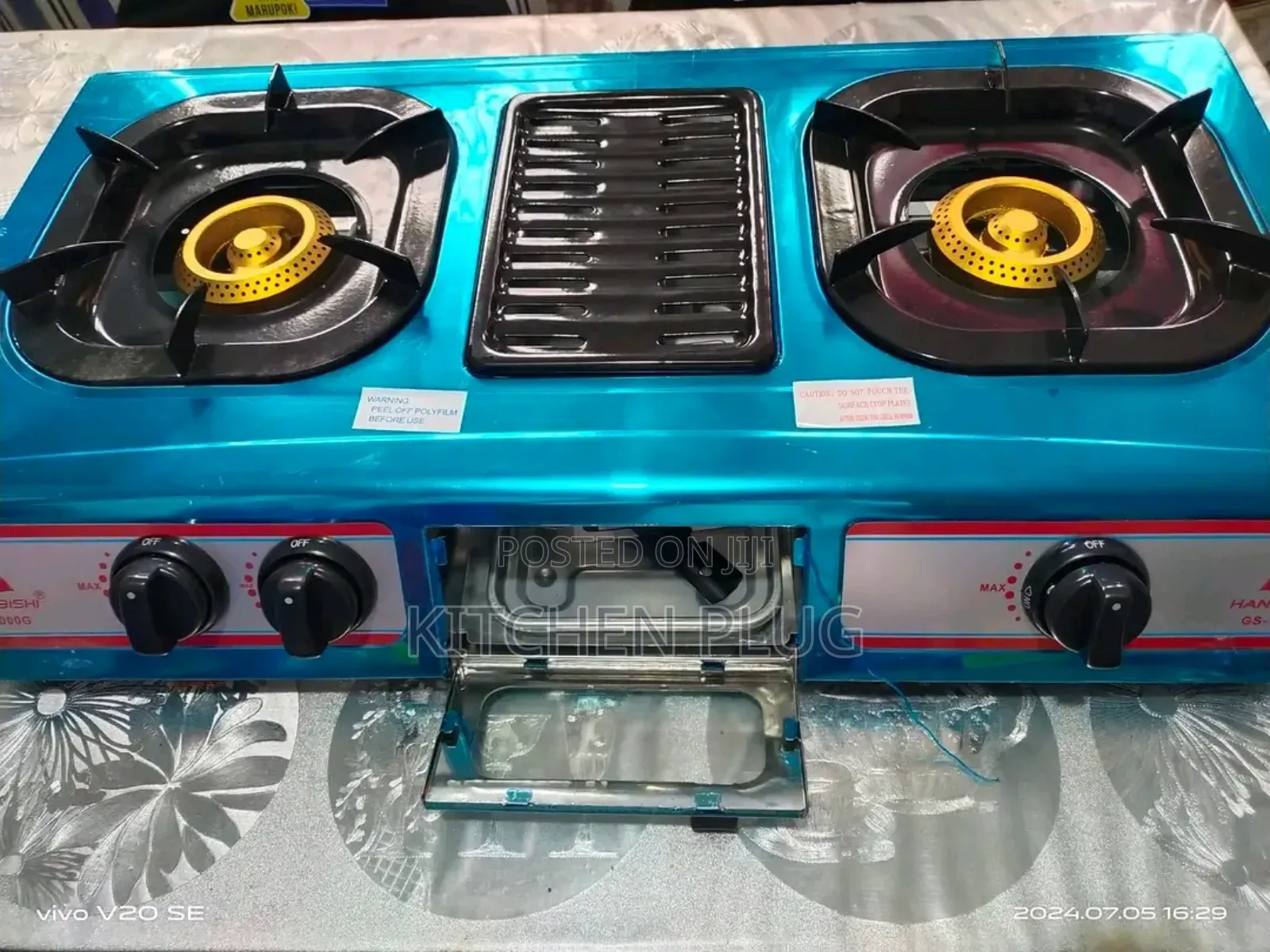 Akai Table Top Gas Cooker Featuring Two Burners and a Central Grill.