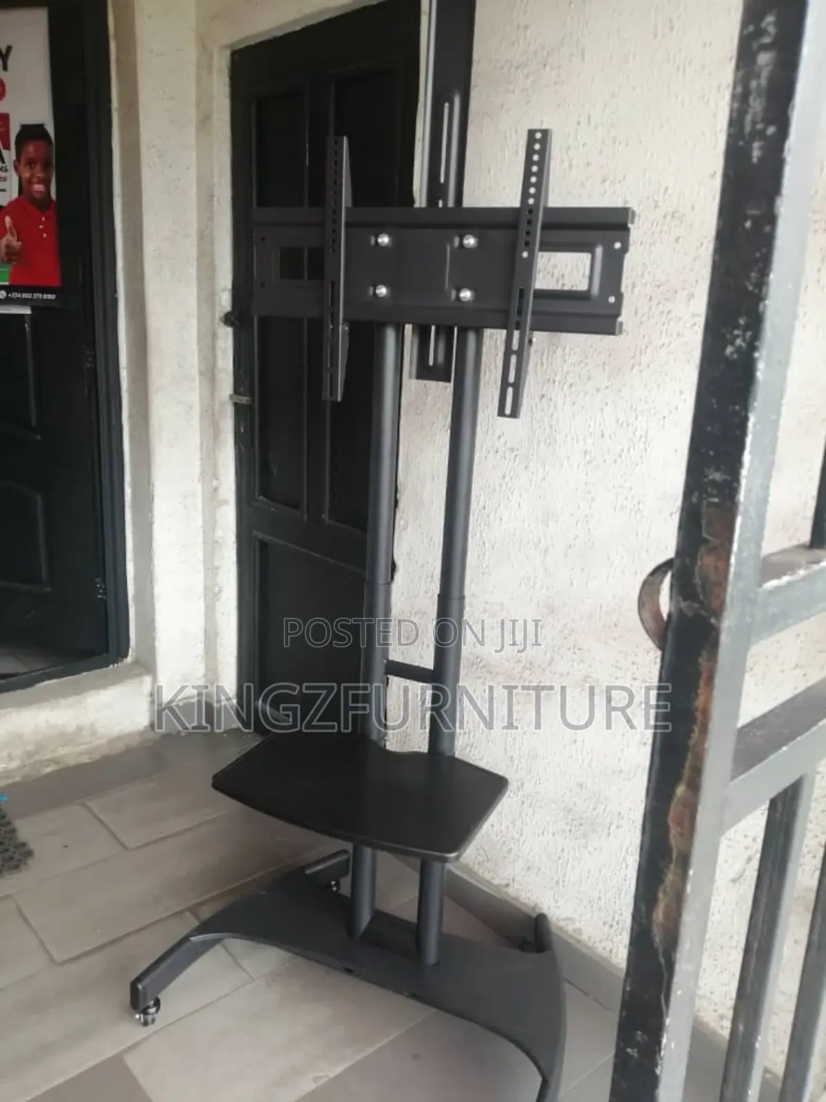 A Black Rolling Mobile Tv Cart, 32 to 75 Inches