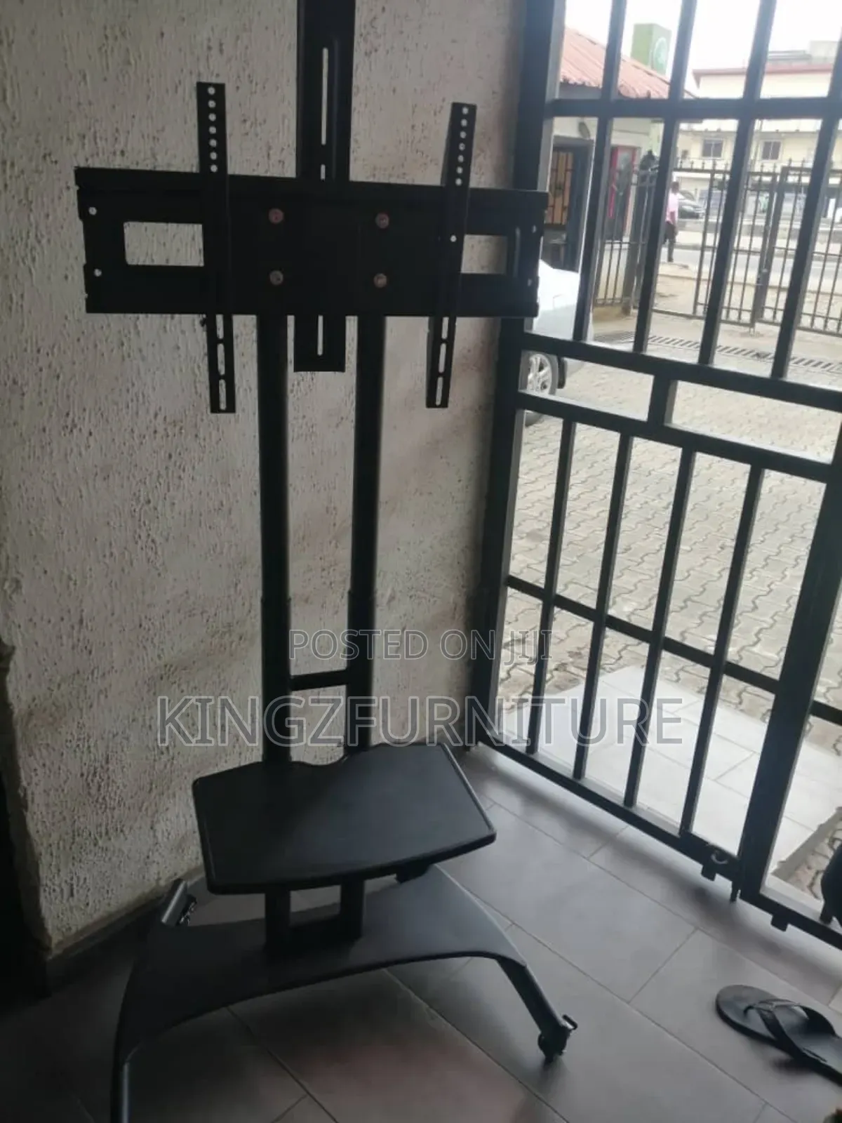 A Black Rolling Mobile Tv Cart, 32 to 75 Inches