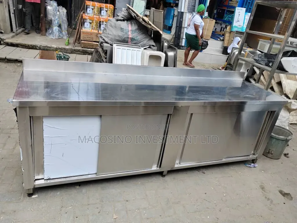 Stainless Steel Commercial Kitchen Work Table Featuring Slide Doors