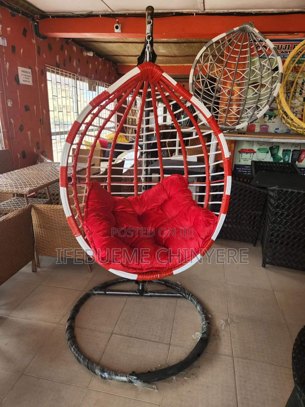 Red and White Swinging Chair With Red and Black Cushion
