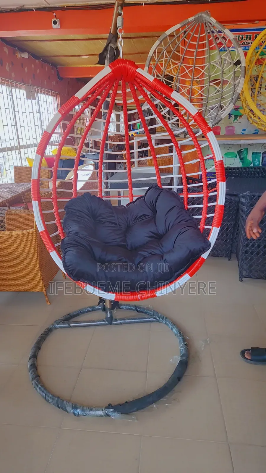 Red and White Swinging Chair With Red and Black Cushion