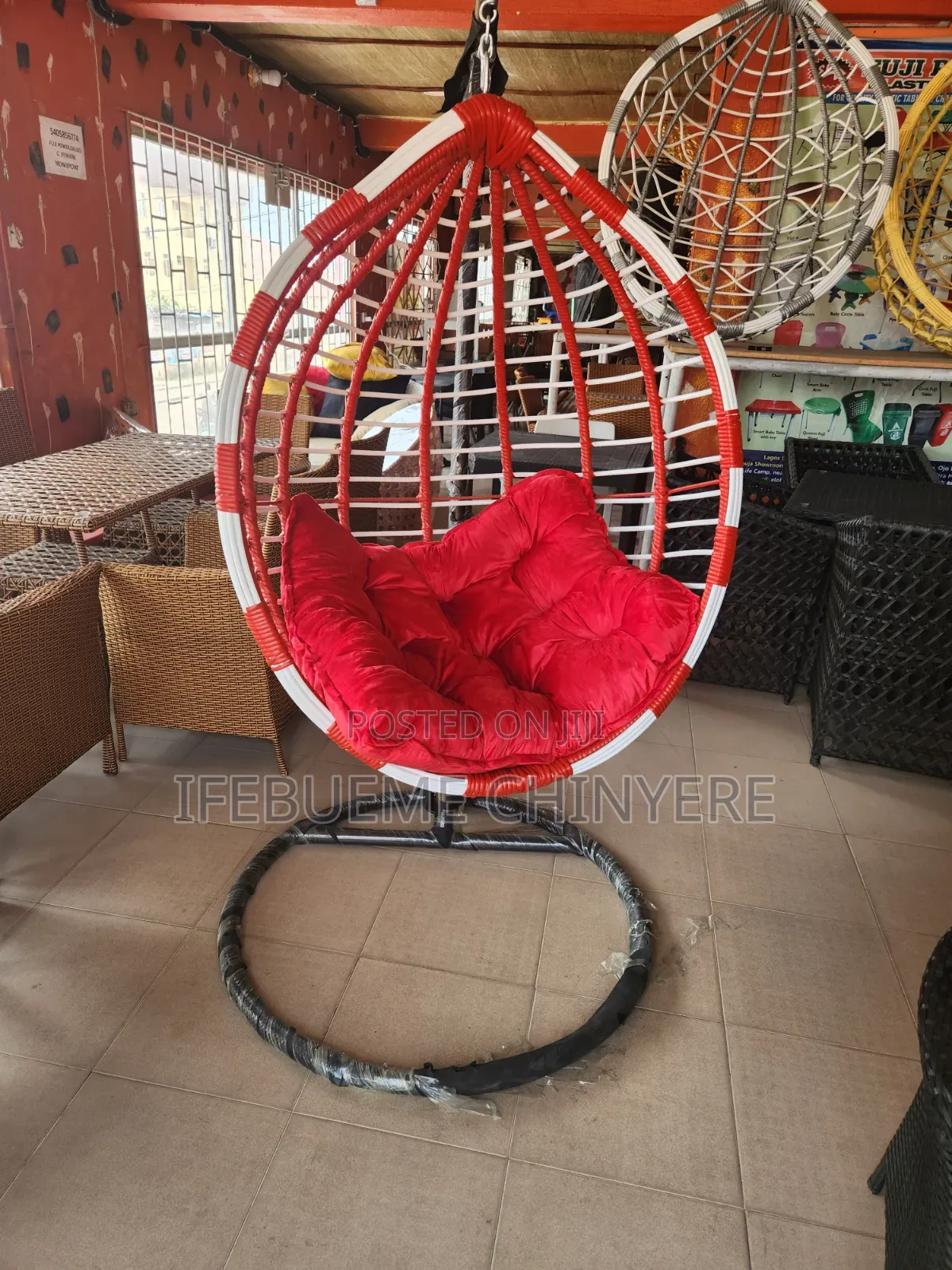 Red and White Swinging Chair With Red and Black Cushion