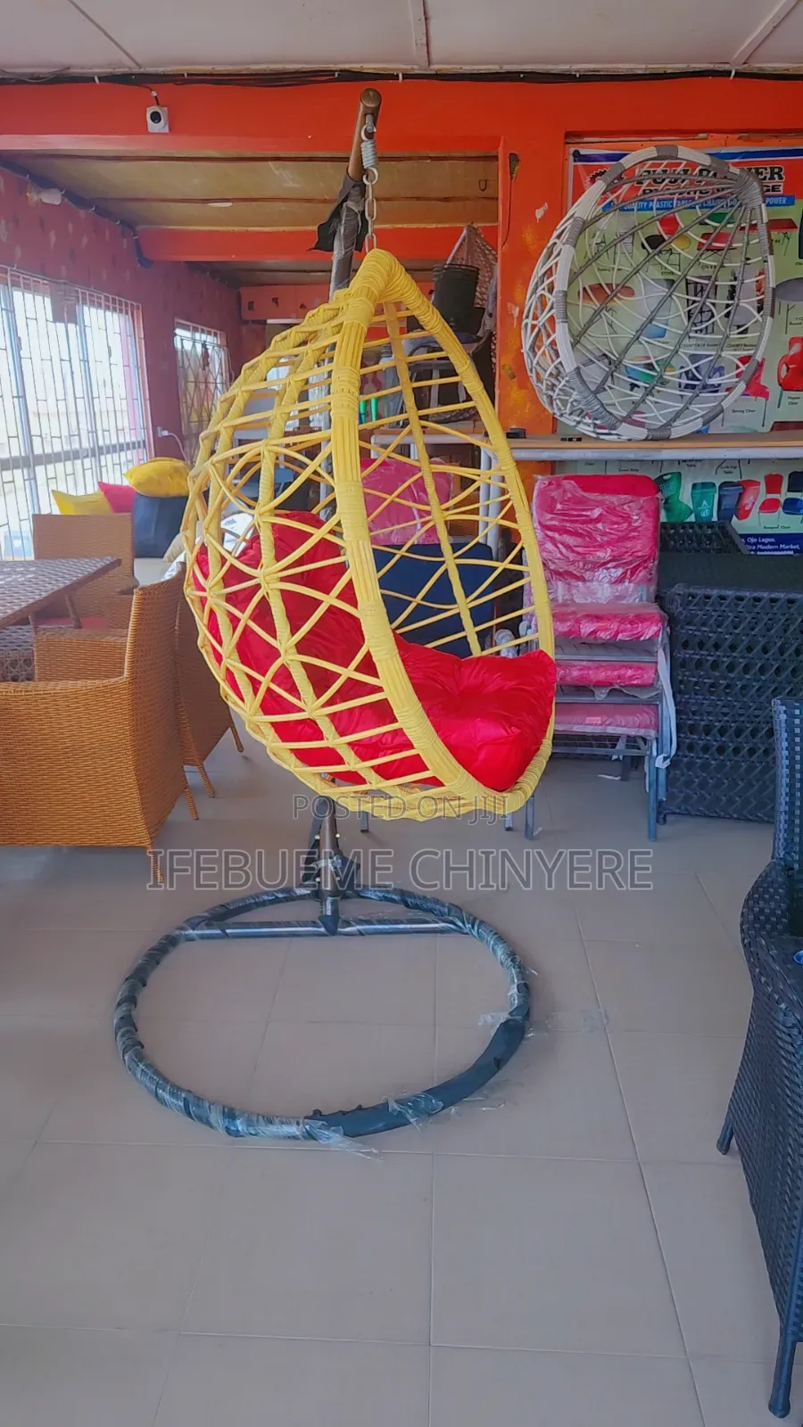 Light Yellow Swinging Chair With Red Cushion