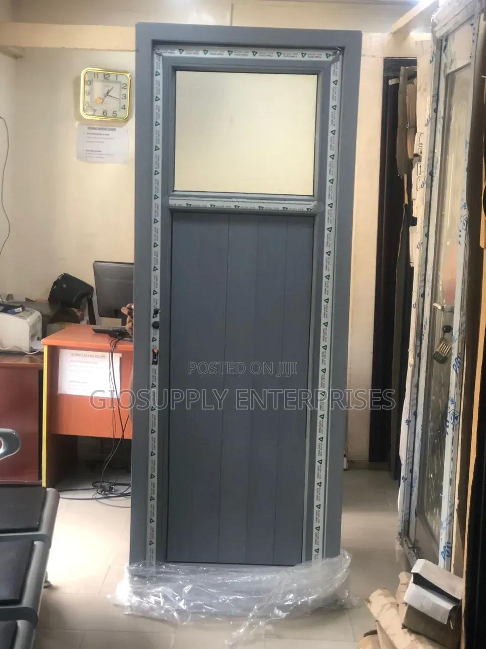 Gray PVC or Aluminum Bathroom Door With a Hinged Design