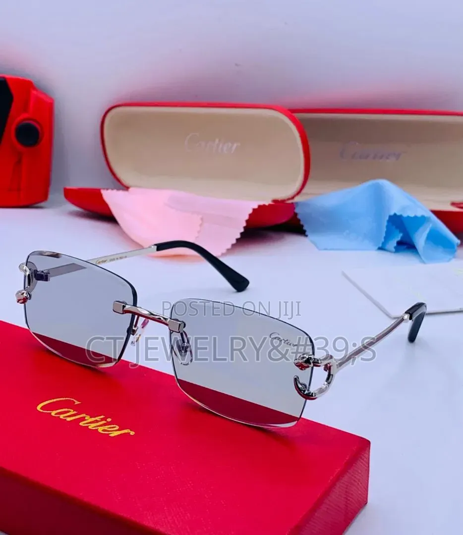 Cartier Sunglasses Featuring a Gold Frame and Blue Tinted Lenses.